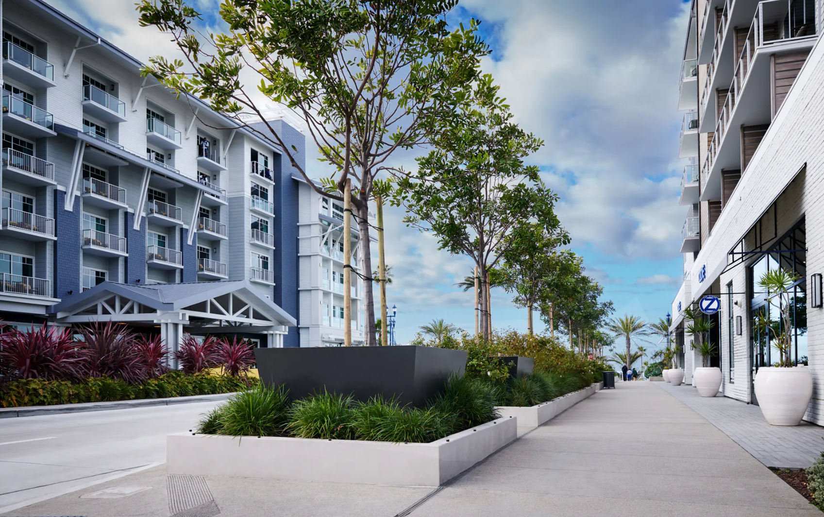 A variety of planter materials, styles, and shapes are featured in a resort corridor 