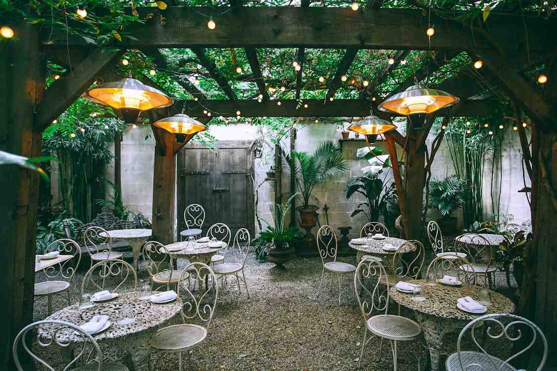 A rustic restaurant patio with soft lighting